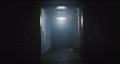A foggy hallway with one dim white light and several old chairs.